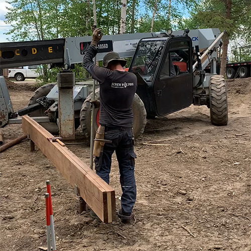 10 foot helical piers being installed for a deck