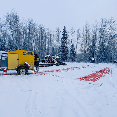 Heater blankets laid out on snow covered ground